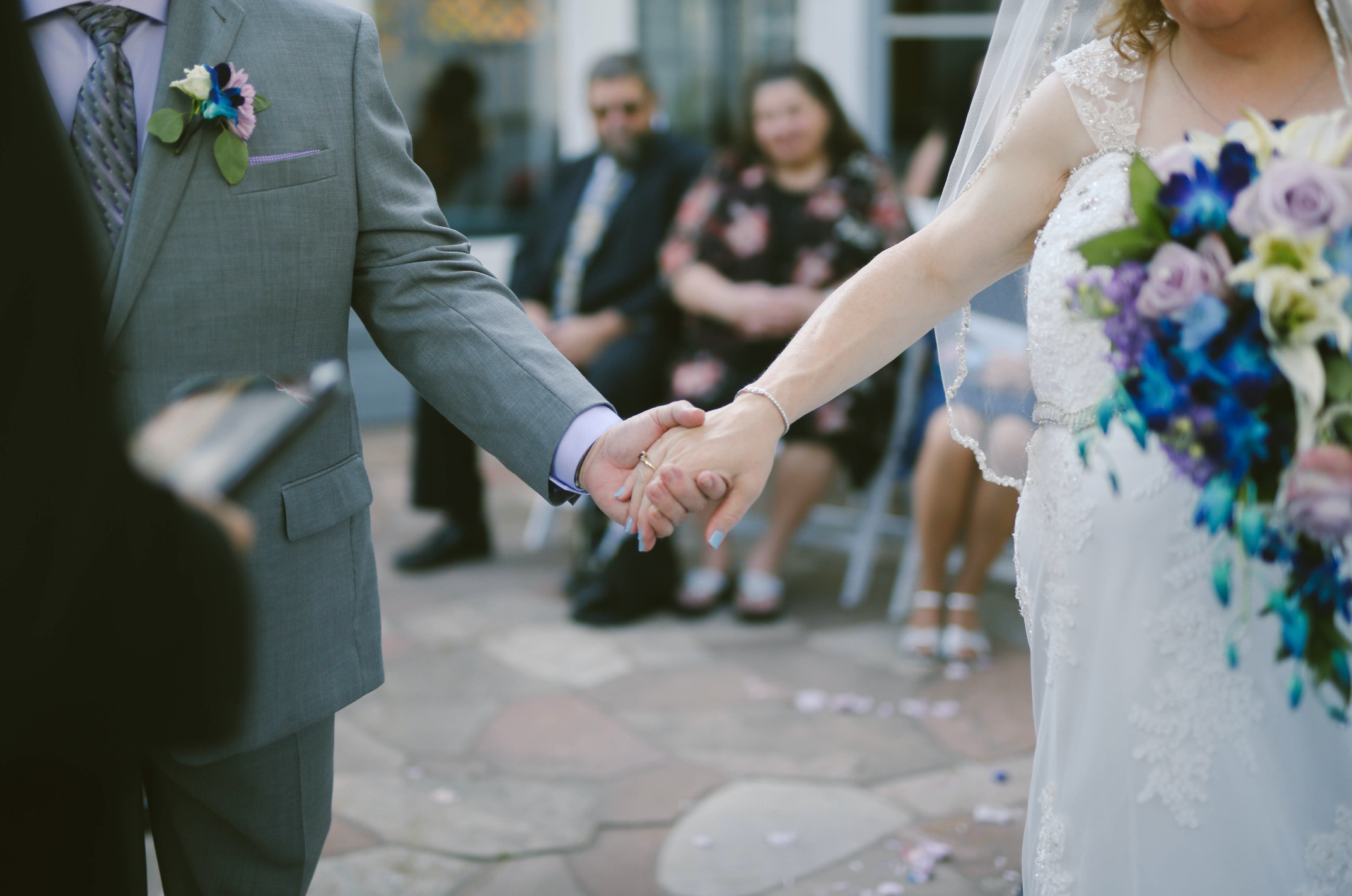 Bride holding hands with groom 